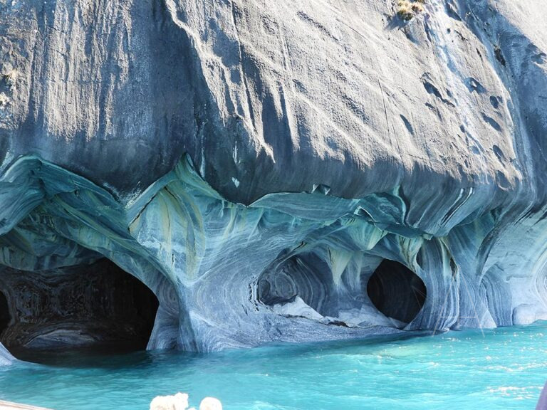 Cuevas en roca azulada junto al agua